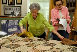 Volunteers analyze a quilt for the statewide research project. Area quilt owners can bring quilts to the Jax Center on Oct. 18, from 10 am to 4 pm for a Quilt Documentation & Discovery Day.